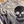 Close-up of a gray sweater featuring a skull design with colorful hand embroidery, showcasing custom sweater repair details.